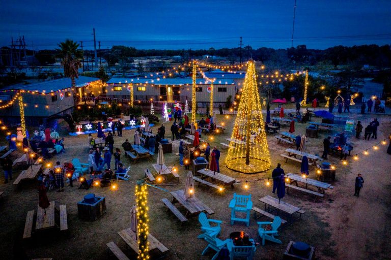 Aerial view of Splashway Campground glowing with Christmas lights at dusk