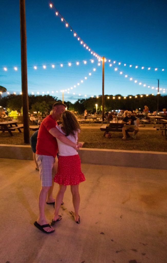 Couple dancing under the string lights at The Hideaway