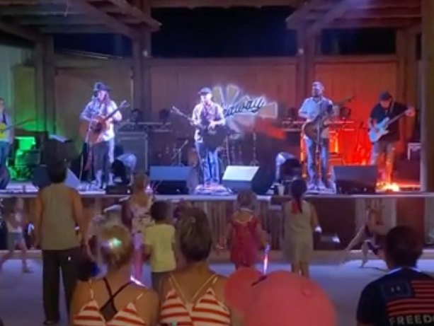 Thompson Brothers Trio performing on the Hideaway stage as kids dance up front