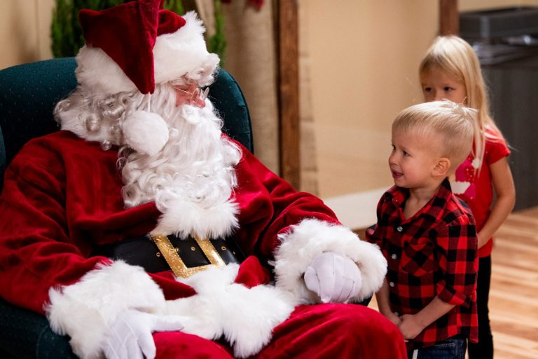 Two kids visiting Santa at Splashway Campground